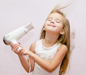 Cute smiling Little girl dries hair isolated